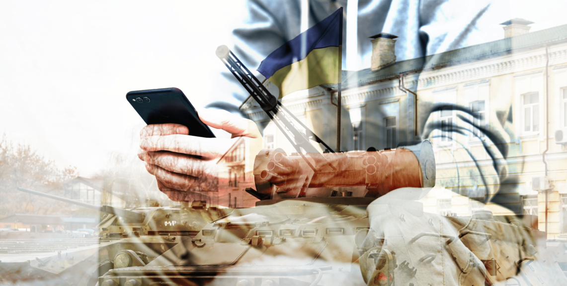 man holding is phone during Ukraine war