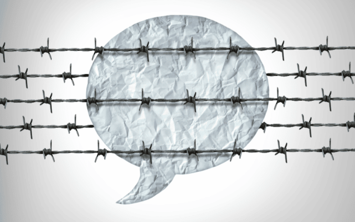 Speech bubble made of crumpled paper with barbed wire representing hate speech