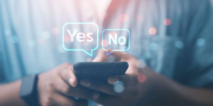 Person holding a smartphone with floating 'Yes' and 'No' icons above the screen, indicating a decision or choice.