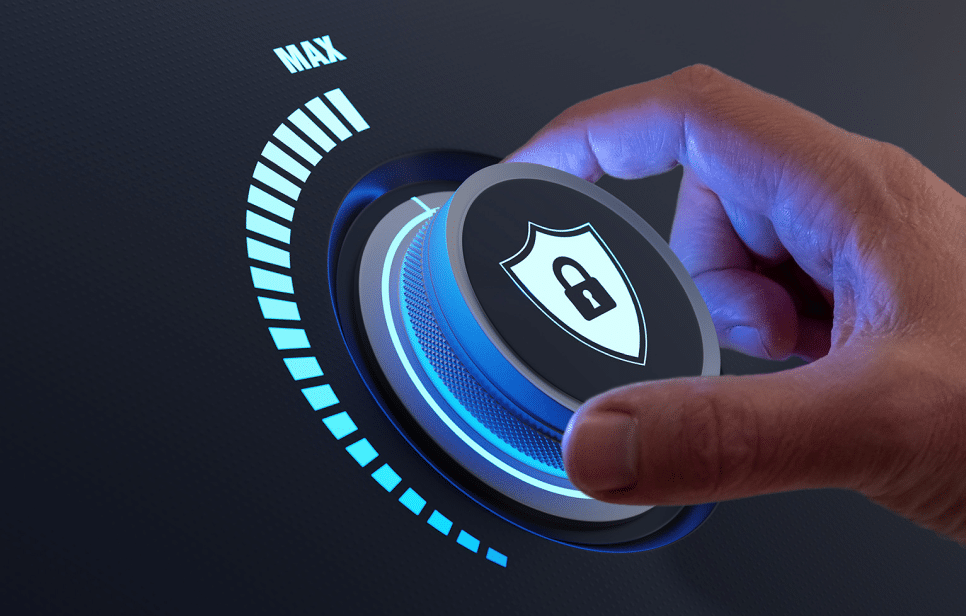 Close-up of a hand turning a security dial to the maximum level, symbolized by a shield with a padlock icon.